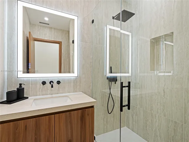 a view of a patio with couches chairs potted plants and floor to ceiling window