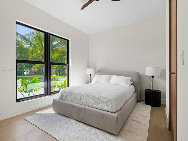 an aerial view of a swimming pool with outdoor seating