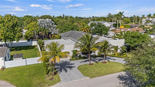a living room with furniture potted plant and a chandelier