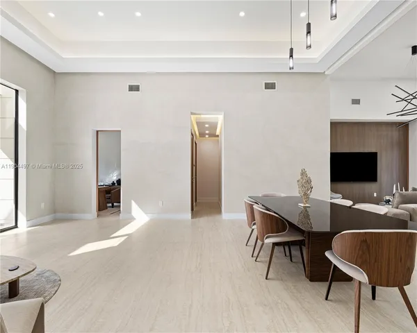 a kitchen with granite countertop a refrigerator and a stove top oven