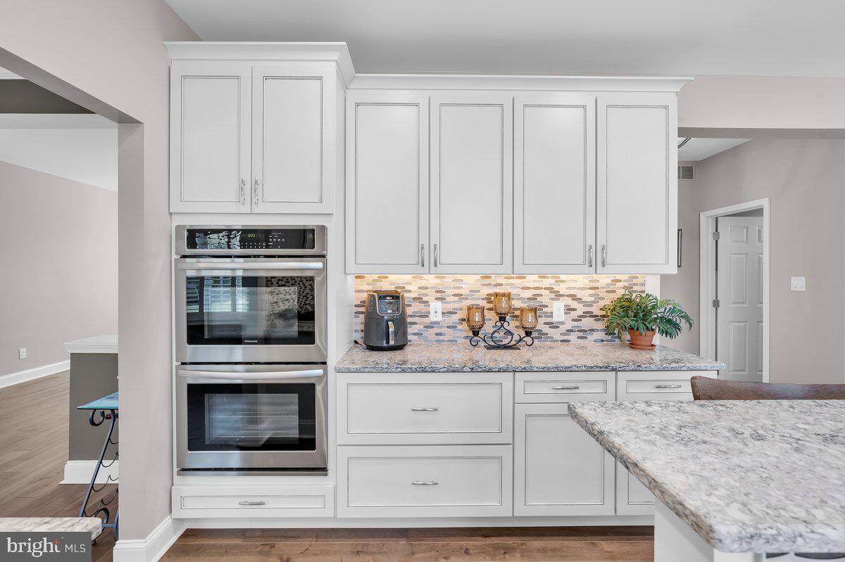 128 Willow Grove Road Shamong, NJ 08088 - Photo 17 of 84 a kitchen with granite countertop white cabinets and stainless steel appliances