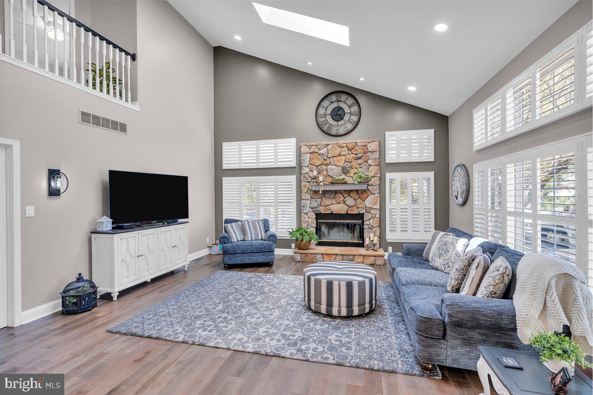 128 Willow Grove Road Shamong, NJ 08088 - Photo 27 of 84 a living room with furniture a flat screen tv and a fireplace