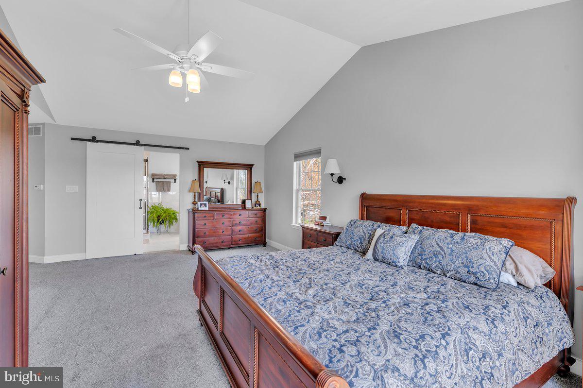 128 Willow Grove Road Shamong, NJ 08088 - Photo 33 of 84 a bedroom with a large bed and a chandelier