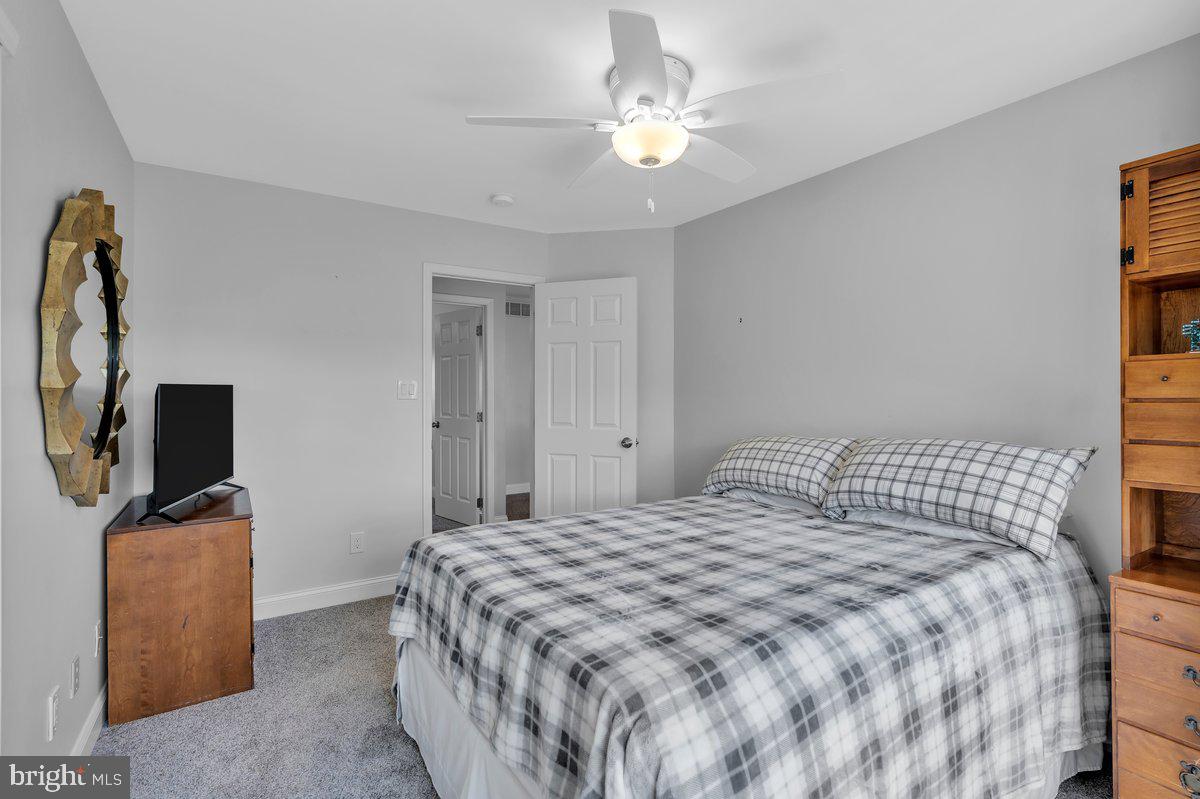 128 Willow Grove Road Shamong, NJ 08088 - Photo 40 of 84 a bedroom with a bed flat screen tv and a window