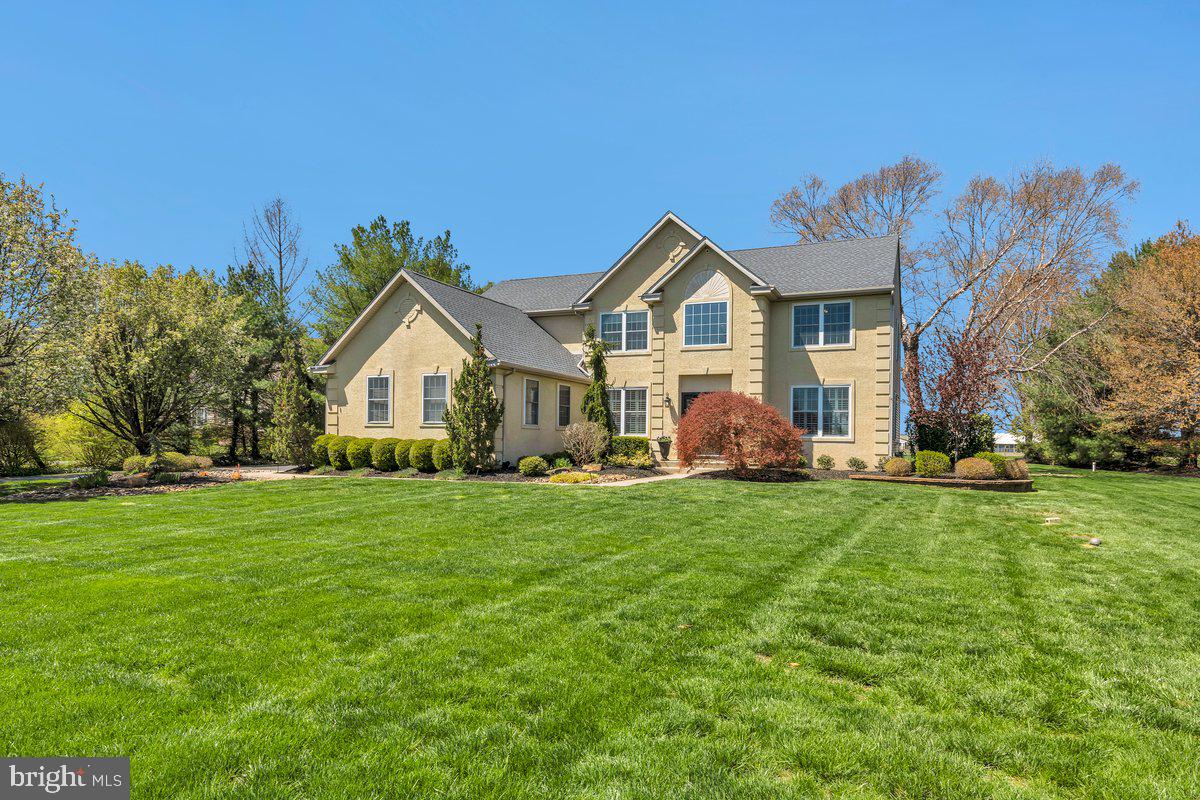 128 Willow Grove Road Shamong, NJ 08088 - Photo 4 of 84 a front view of a house with a yard and trees