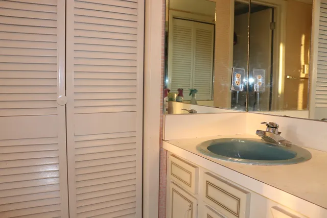 a bathroom with a shower and a glass door