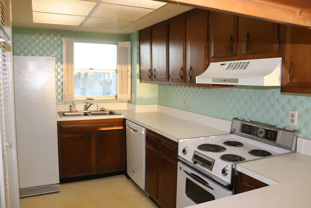 a kitchen that has a sink and a stove