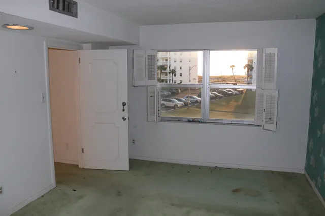 a view of an empty room with a window