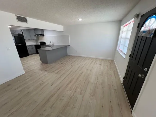 a room with wooden floors and glass door