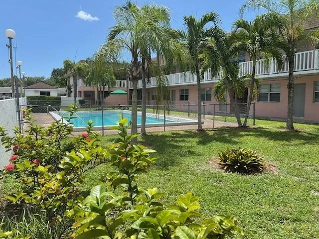 a garden with trees in front of it
