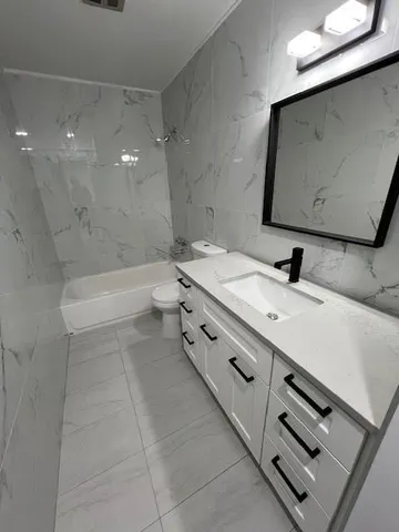 a bathroom with a sink a toilet and a bathtub