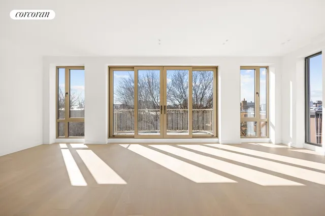 a living room with furniture a rug and a large window