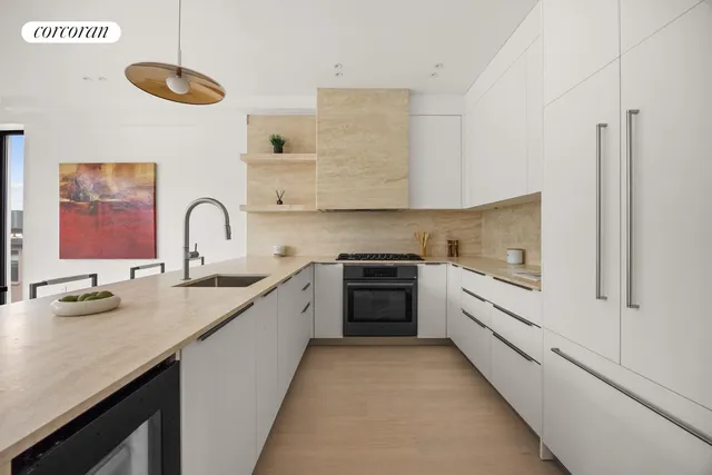 a kitchen with stainless steel appliances kitchen island a table chairs sink and cabinets