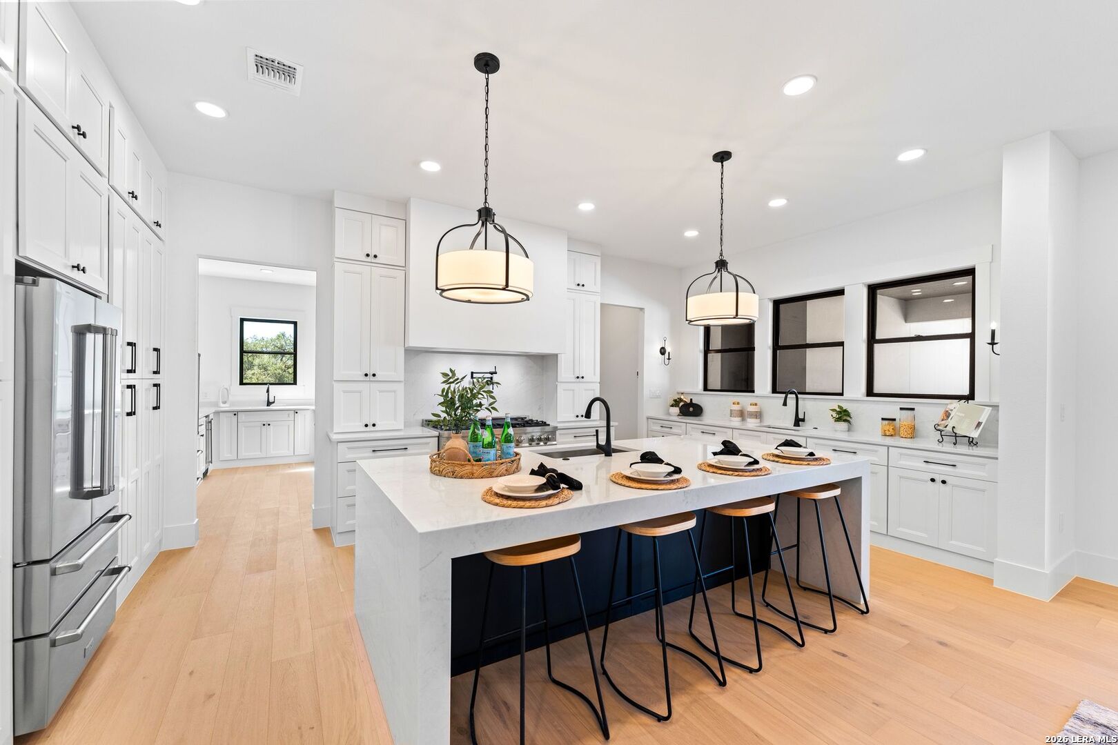 34793 High Gate Road Bulverde, TX 78163 - Photo 12 of 50 a view of a dining room and livingroom with furniture wooden floor a chandelier