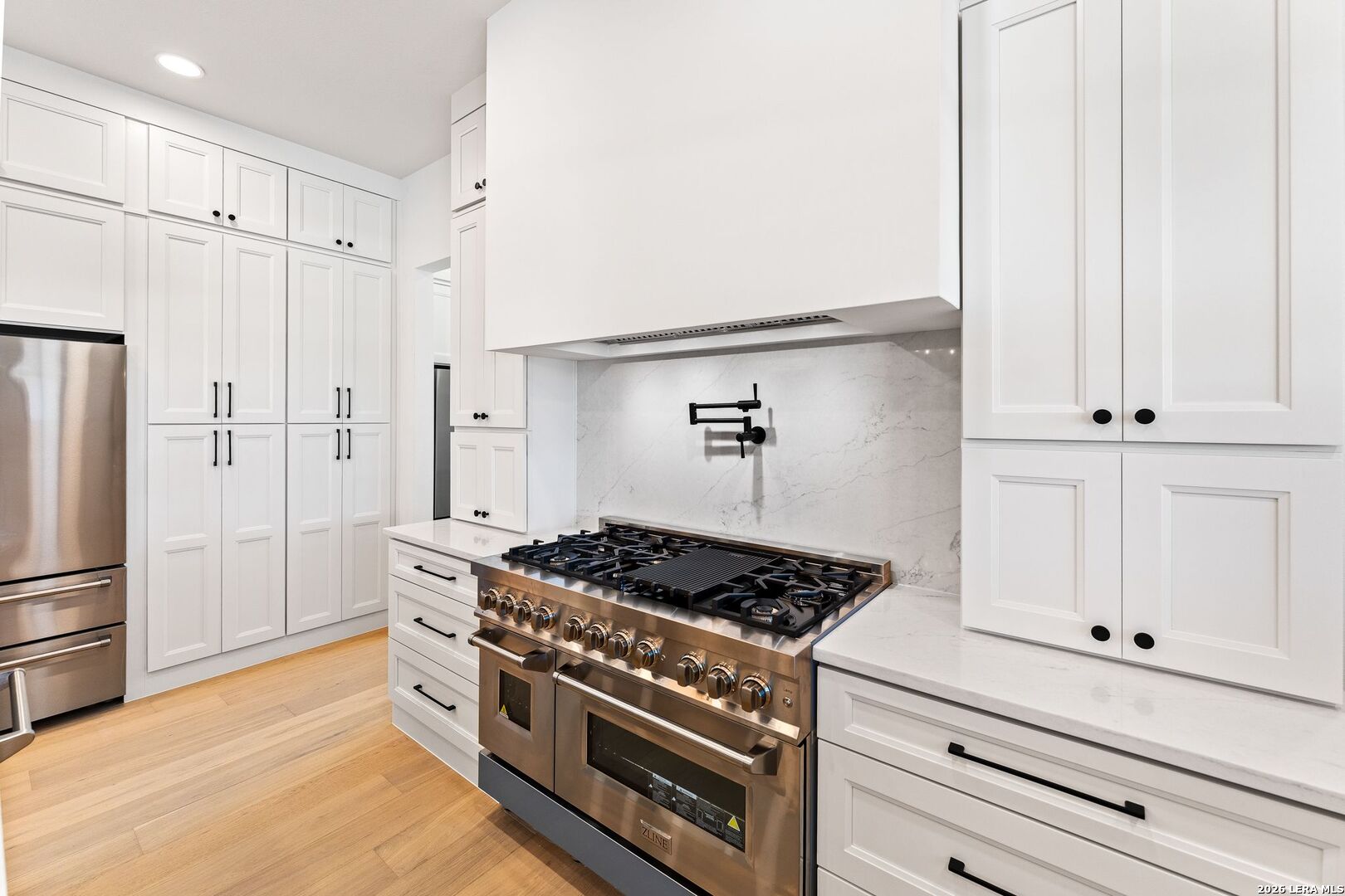 34793 High Gate Road Bulverde, TX 78163 - Photo 16 of 50 a kitchen with white cabinets and appliances