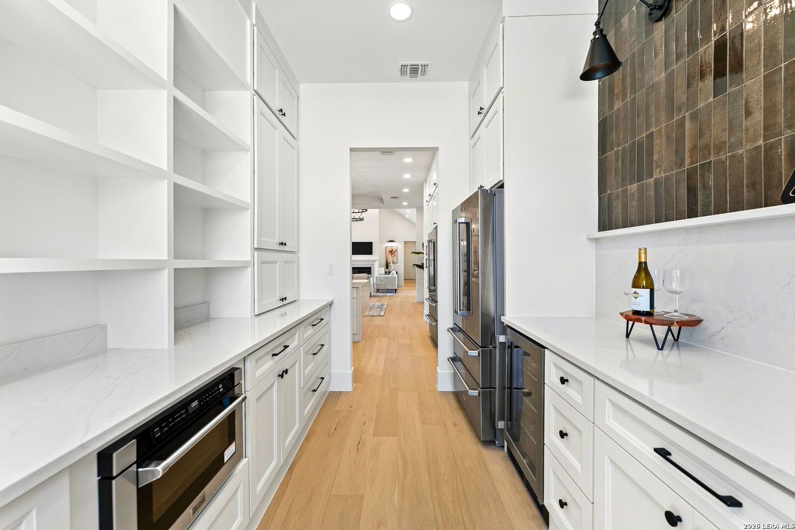 34793 High Gate Road Bulverde, TX 78163 - Photo 18 of 50 a hallway with cabinets and wooden floor