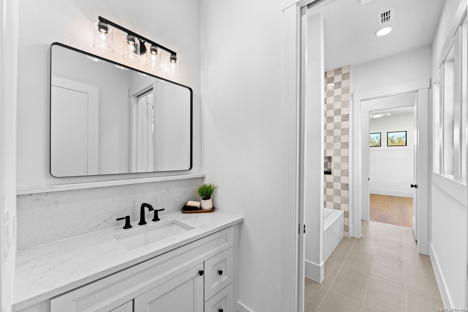 34793 High Gate Road Bulverde, TX 78163 - Photo 22 of 50 a bathroom with a sink and a mirror