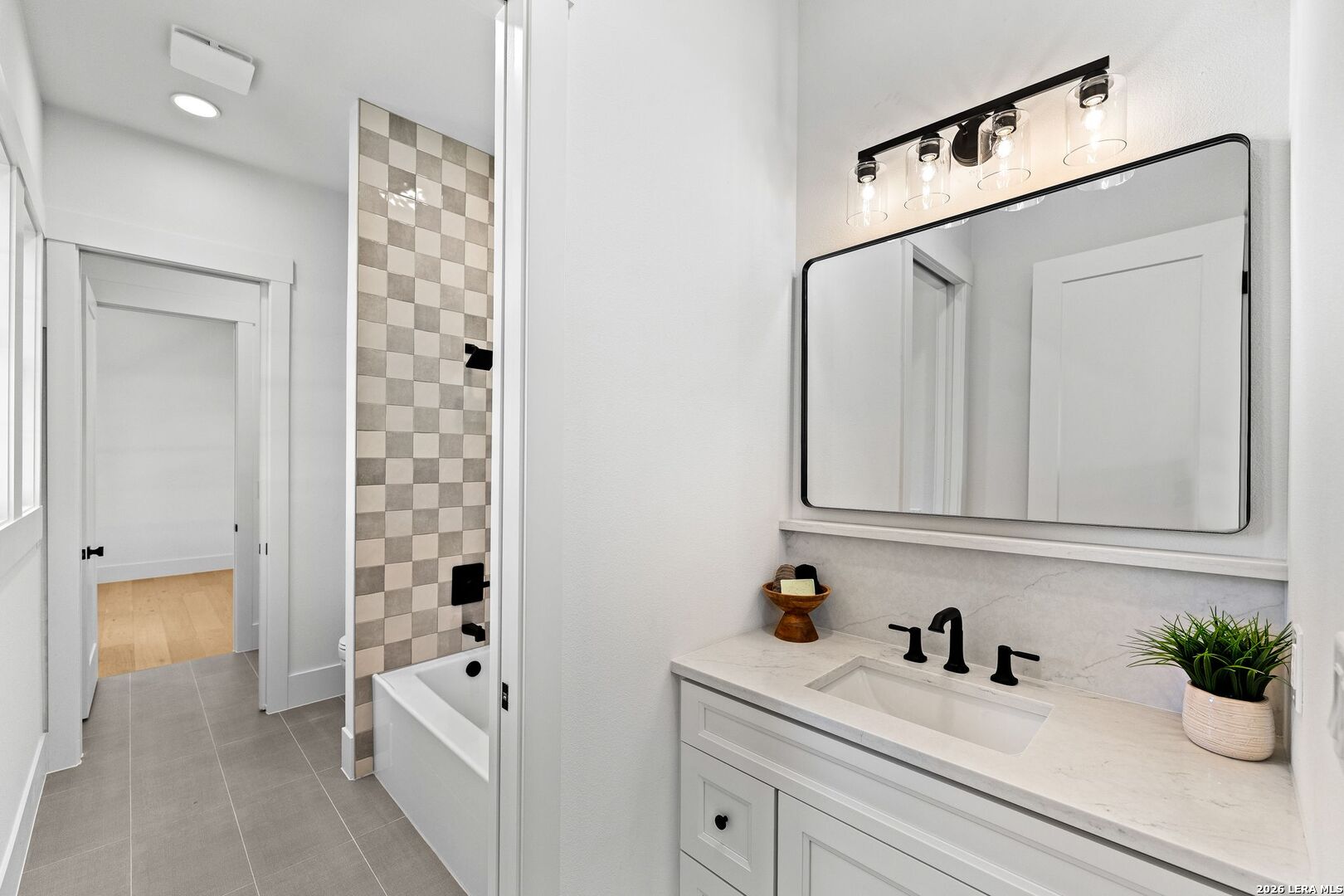 34793 High Gate Road Bulverde, TX 78163 - Photo 24 of 50 a hallway with white cabinets and wooden floor