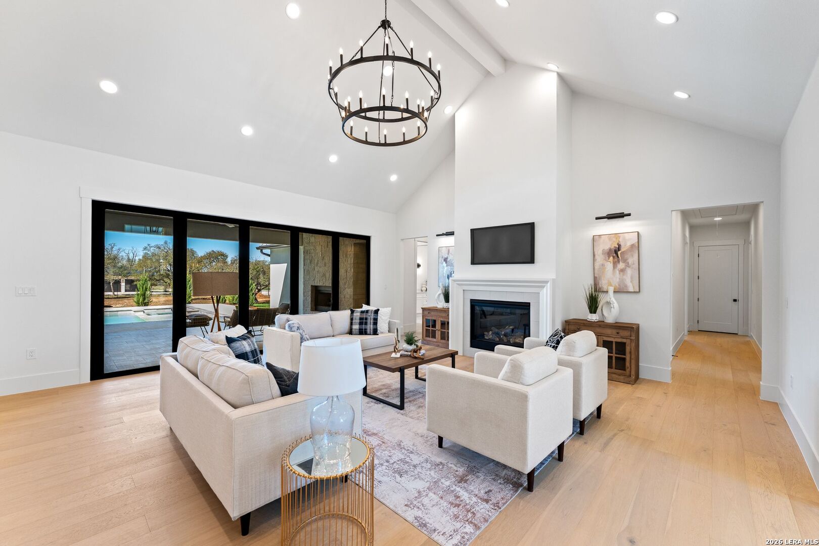 34793 High Gate Road Bulverde, TX 78163 - Photo 7 of 50 a living room with fireplace furniture and a chandelier