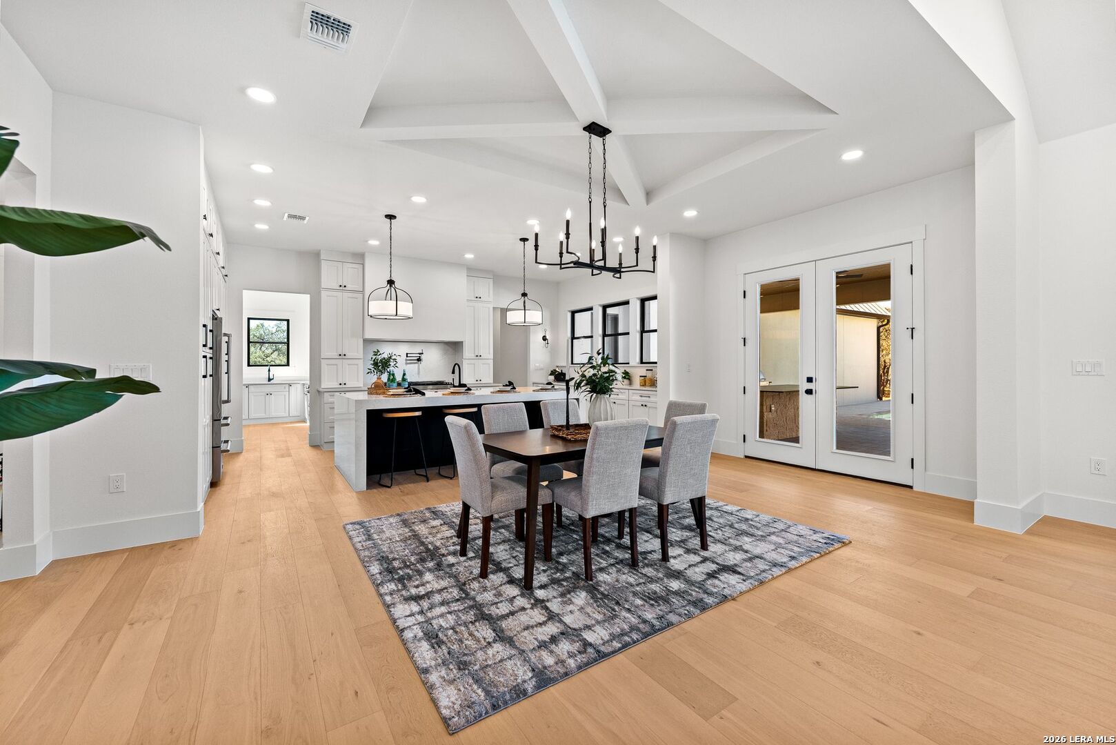 34793 High Gate Road Bulverde, TX 78163 - Photo 10 of 50 an open kitchen with dining table and sink