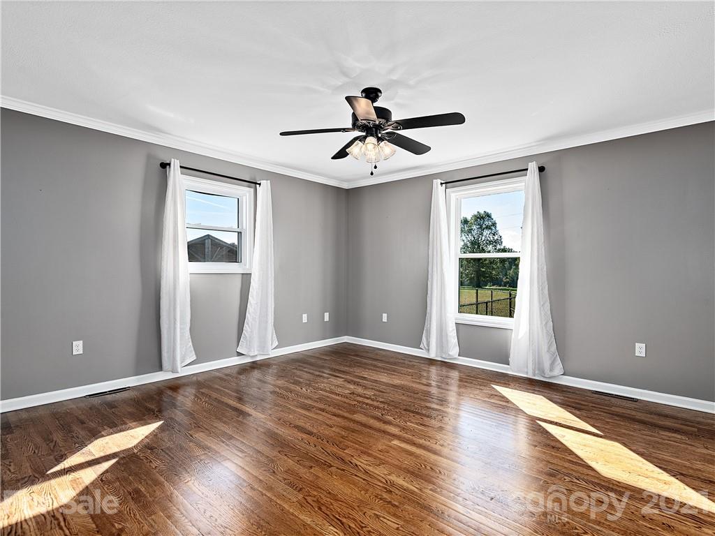 588 Lee Cudd Road Rutherfordton, NC 28139 - Photo 11 of 42 a view of a room with wooden floor and ceiling fan