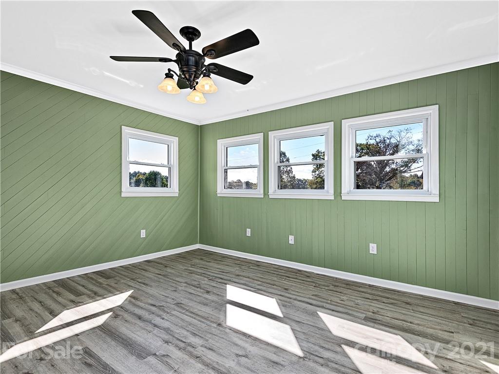588 Lee Cudd Road Rutherfordton, NC 28139 - Photo 15 of 42 a view of a room with wooden floor ceiling fan and windows
