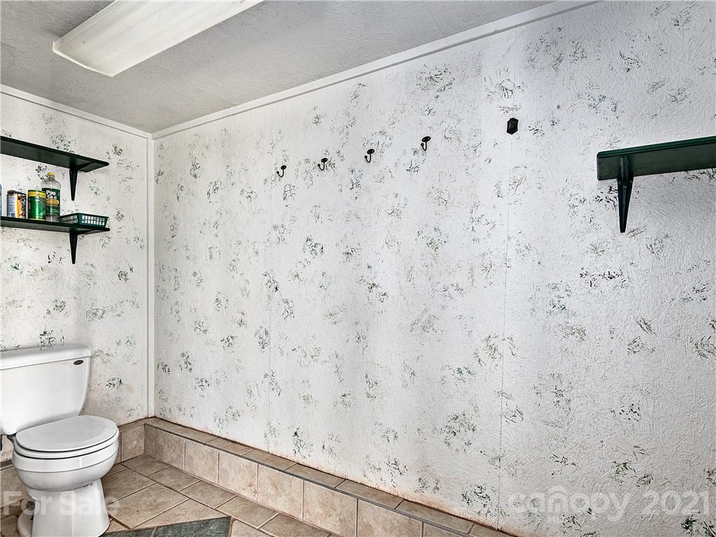 588 Lee Cudd Road Rutherfordton, NC 28139 - Photo 26 of 42 a bathroom with a toilet and a shower curtain