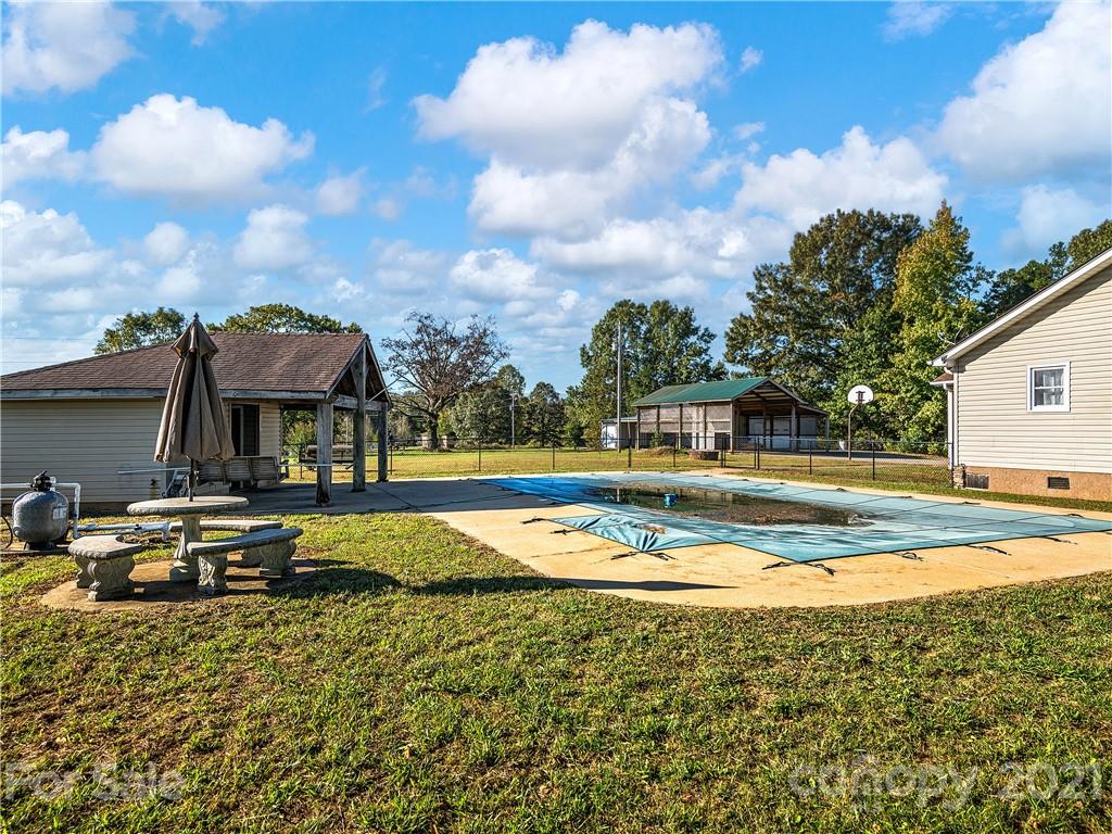588 Lee Cudd Road Rutherfordton, NC 28139 - Photo 30 of 42 a view of a swimming pool with outdoor seating and a yard