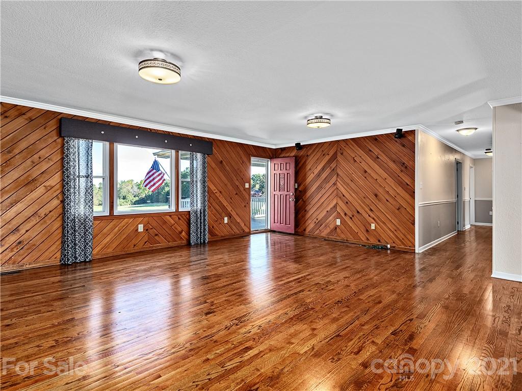 588 Lee Cudd Road Rutherfordton, NC 28139 - Photo 4 of 42 a view of an empty room with wooden floor and a window