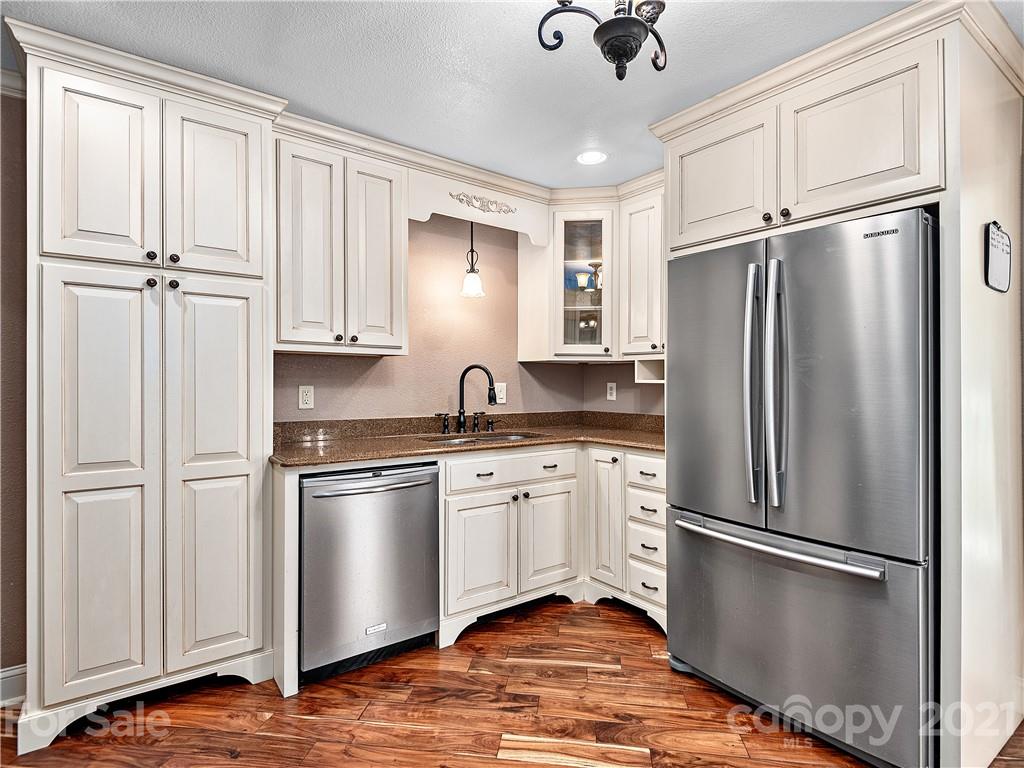 588 Lee Cudd Road Rutherfordton, NC 28139 - Photo 5 of 42 a kitchen with stainless steel appliances granite countertop a refrigerator sink and white cabinets