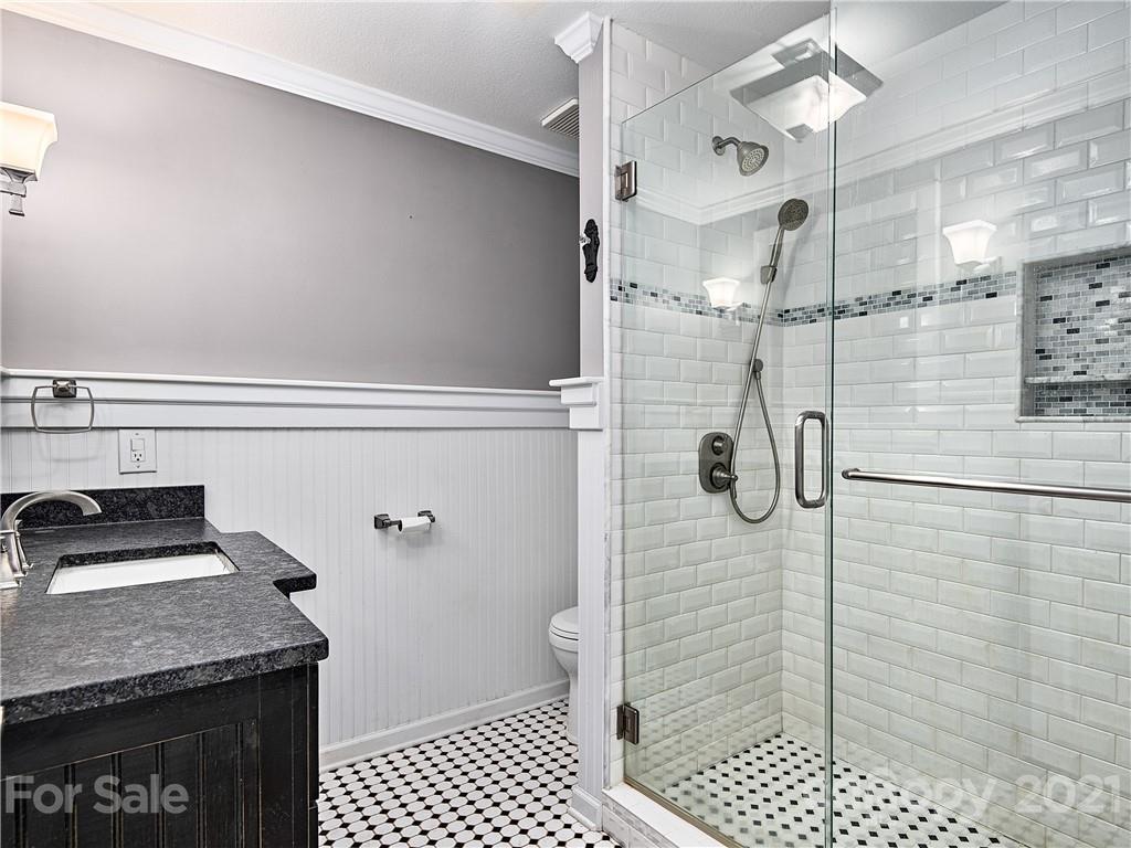 588 Lee Cudd Road Rutherfordton, NC 28139 - Photo 9 of 42 a bathroom with a granite countertop sink a toilet and shower