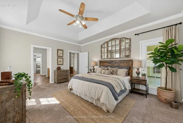 a bedroom with a balcony a bed a dresser and potted plant