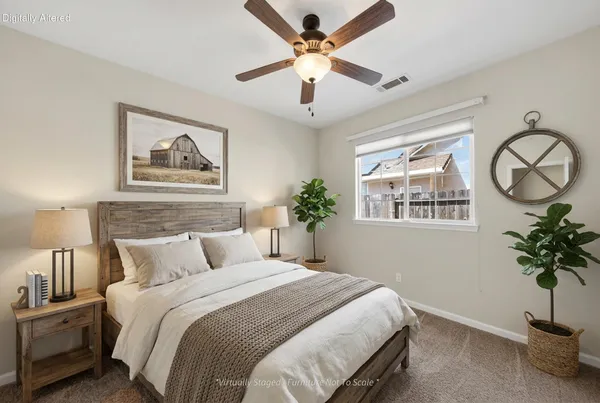 a bedroom with a bed and a potted plant