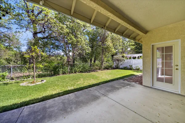 a view of a backyard with swimming pool