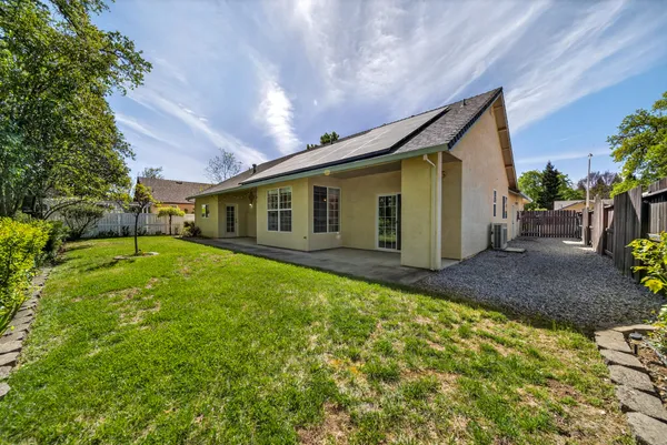 a view of a house with backyard and sitting area