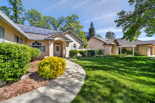 a front view of a house with garden
