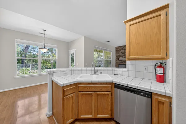 a kitchen with stainless steel appliances granite countertop a sink and a window