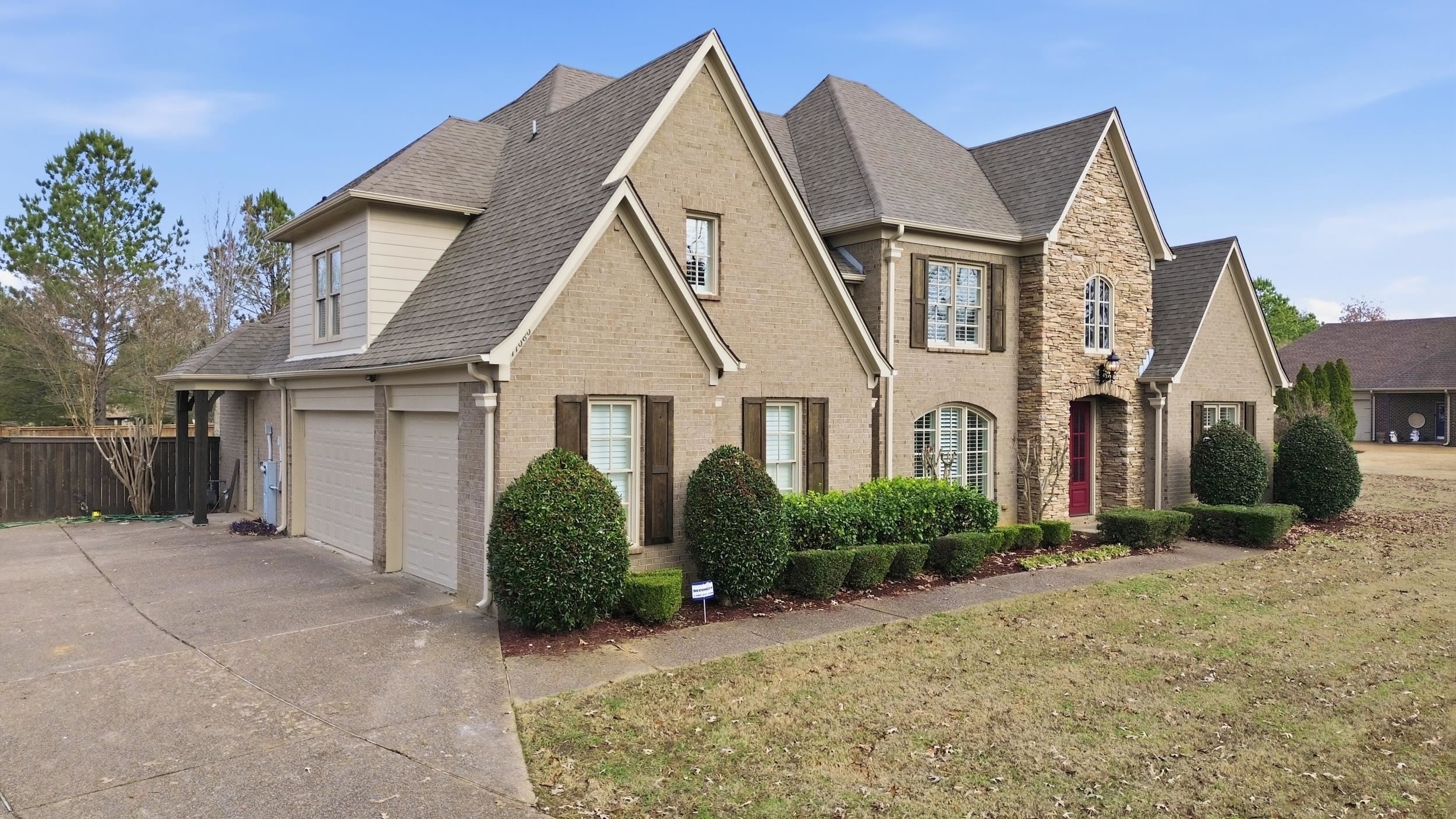 a view of a white house next to a yard