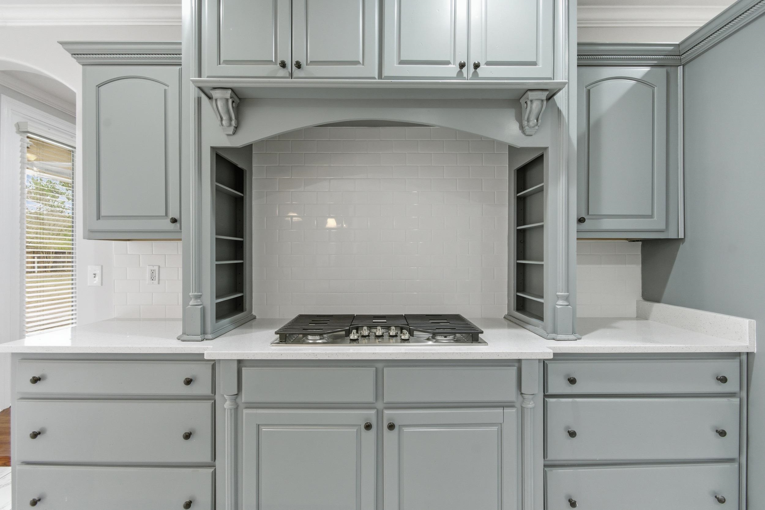 11080 Shelby Post Road Collierville, TN 38017 - Photo 11 of 39 Kitchen featuring ornamental molding, backsplash, light stone countertops, stainless steel gas cooktop, and gray cabinets