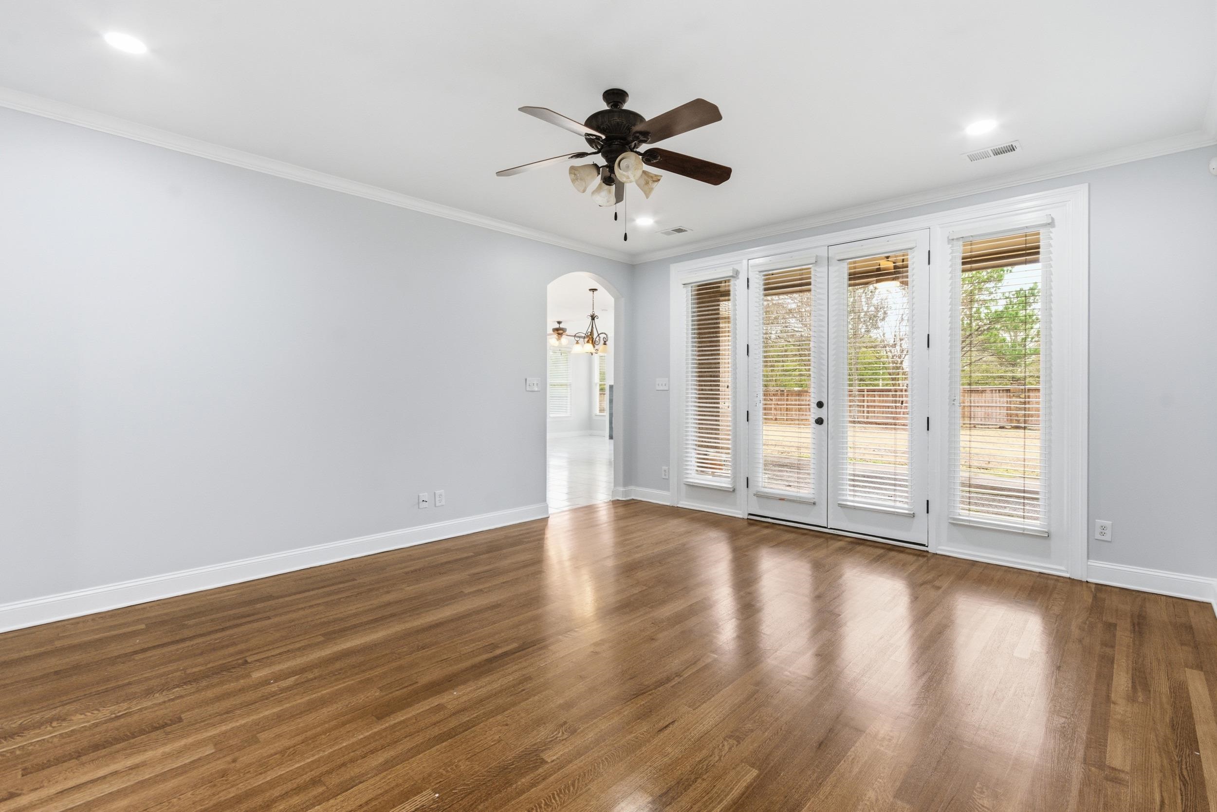 11080 Shelby Post Road Collierville, TN 38017 - Photo 15 of 39 Spare room featuring crown molding, arched walkways, wood finished floors, recessed lighting, and ceiling fan