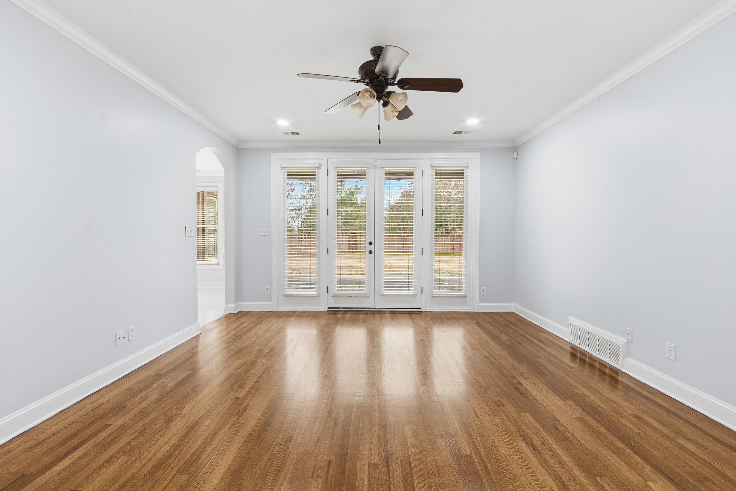 11080 Shelby Post Road Collierville, TN 38017 - Photo 16 of 39 Spare room with wood finished floors, crown molding, arched walkways, and ceiling fan