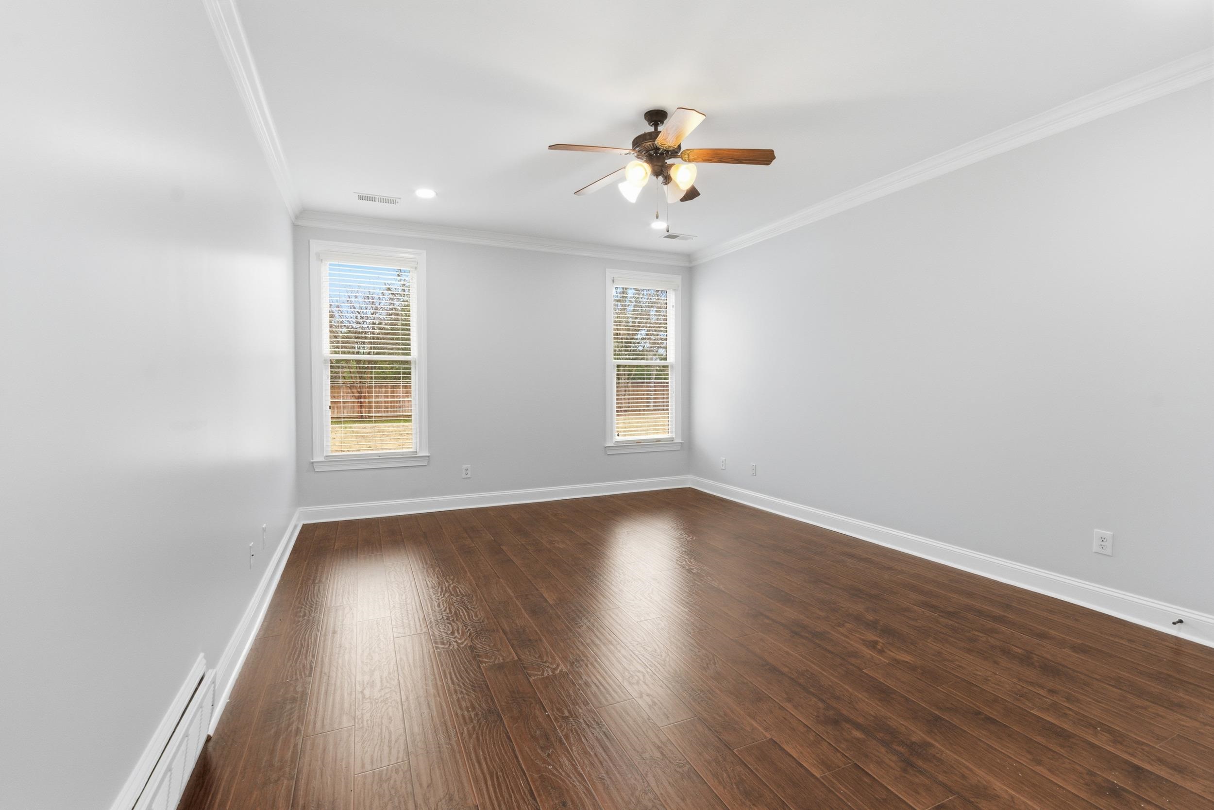 11080 Shelby Post Road Collierville, TN 38017 - Photo 17 of 39 Unfurnished room with crown molding, baseboard heating, dark wood-style flooring, ceiling fan, and recessed lighting