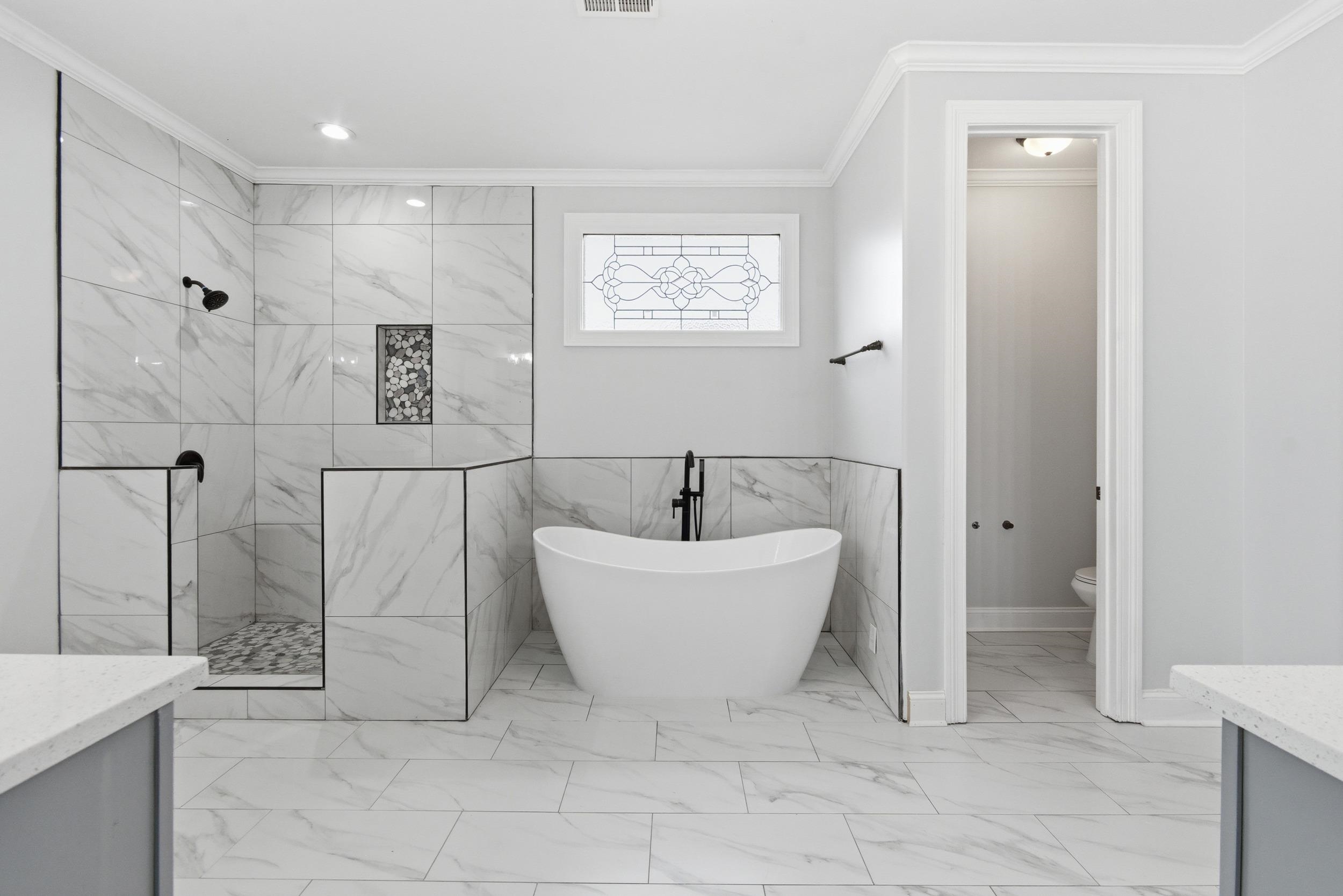 11080 Shelby Post Road Collierville, TN 38017 - Photo 18 of 39 Bathroom featuring vanity, light marble finish flooring, a soaking tub, a marble finish shower, and ornamental molding