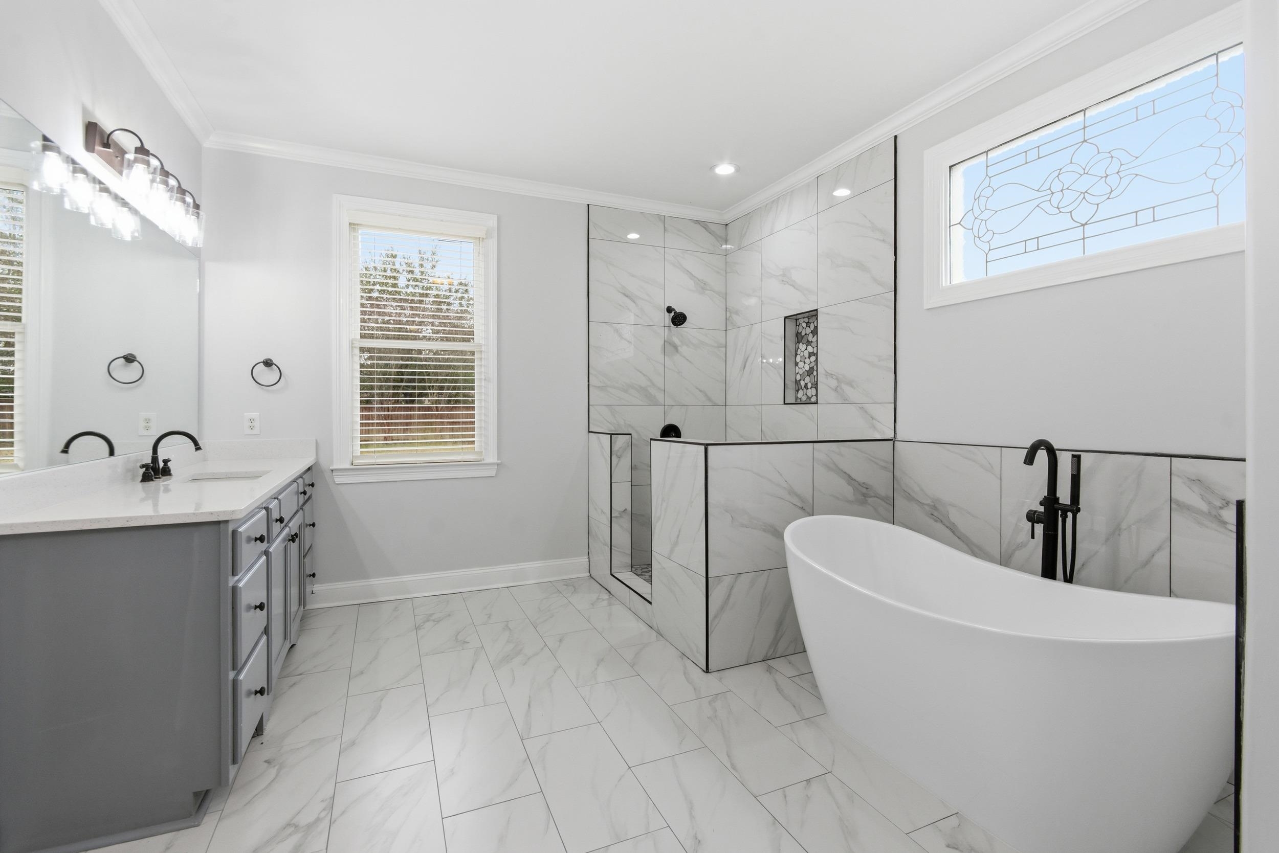 11080 Shelby Post Road Collierville, TN 38017 - Photo 19 of 39 Full bathroom featuring light marble finish flooring, a soaking tub, a marble finish shower, vanity, and crown molding