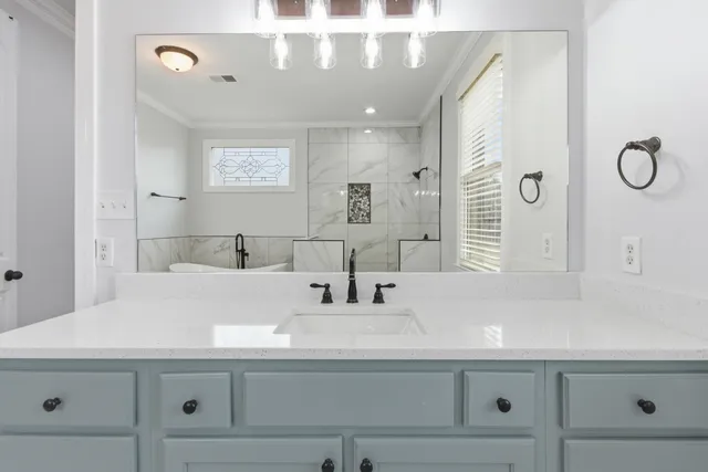 a bathroom with a sink and a mirror