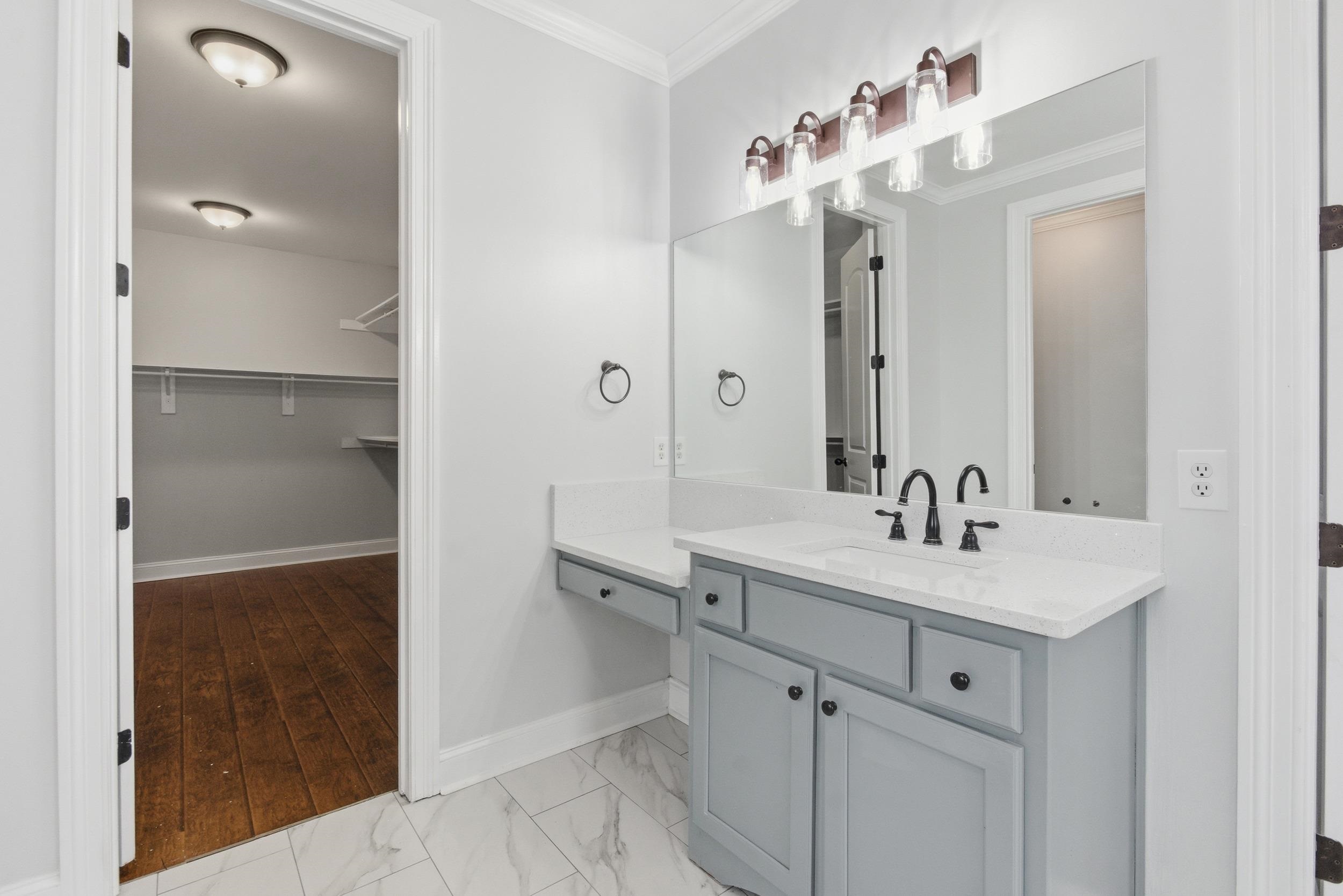 11080 Shelby Post Road Collierville, TN 38017 - Photo 22 of 39 Full bathroom featuring vanity, crown molding, light marble finish flooring, and a spacious closet