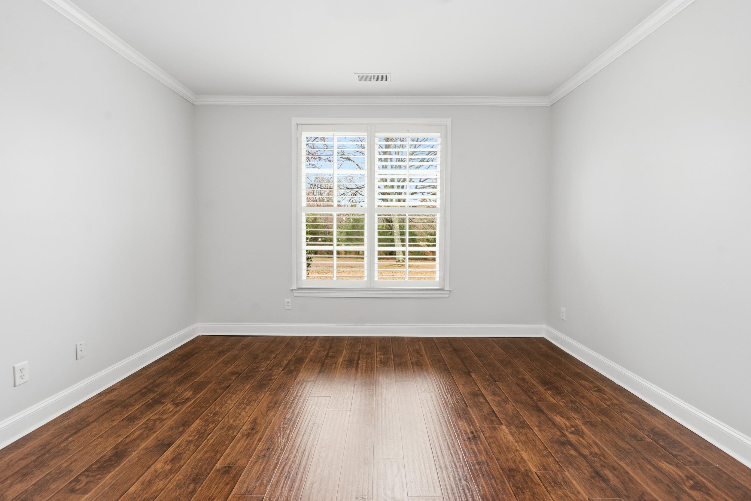 11080 Shelby Post Road Collierville, TN 38017 - Photo 24 of 39 Unfurnished room featuring ornamental molding and dark wood-type flooring