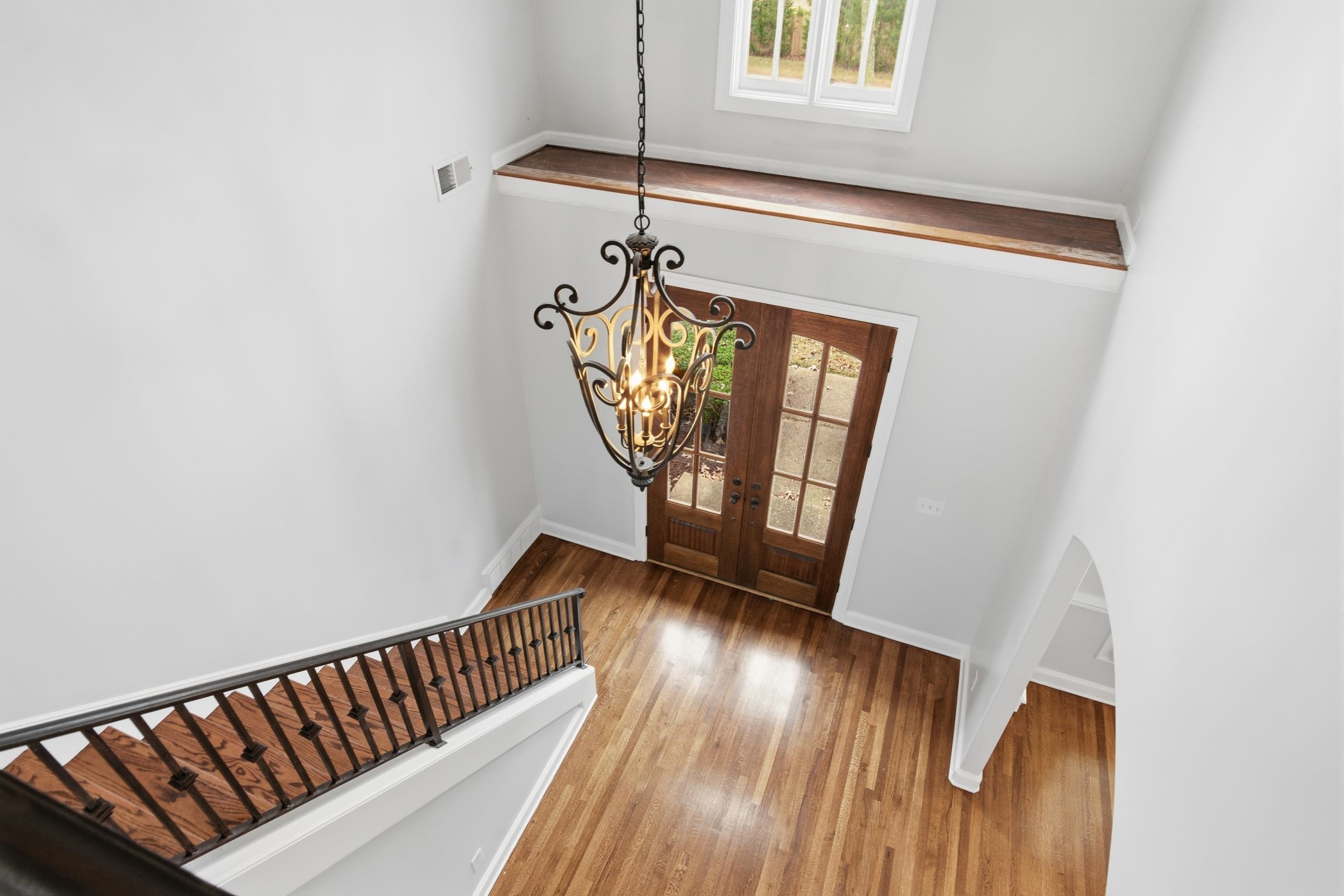 11080 Shelby Post Road Collierville, TN 38017 - Photo 27 of 39 Entrance foyer with french doors, a chandelier, and wood finished floors