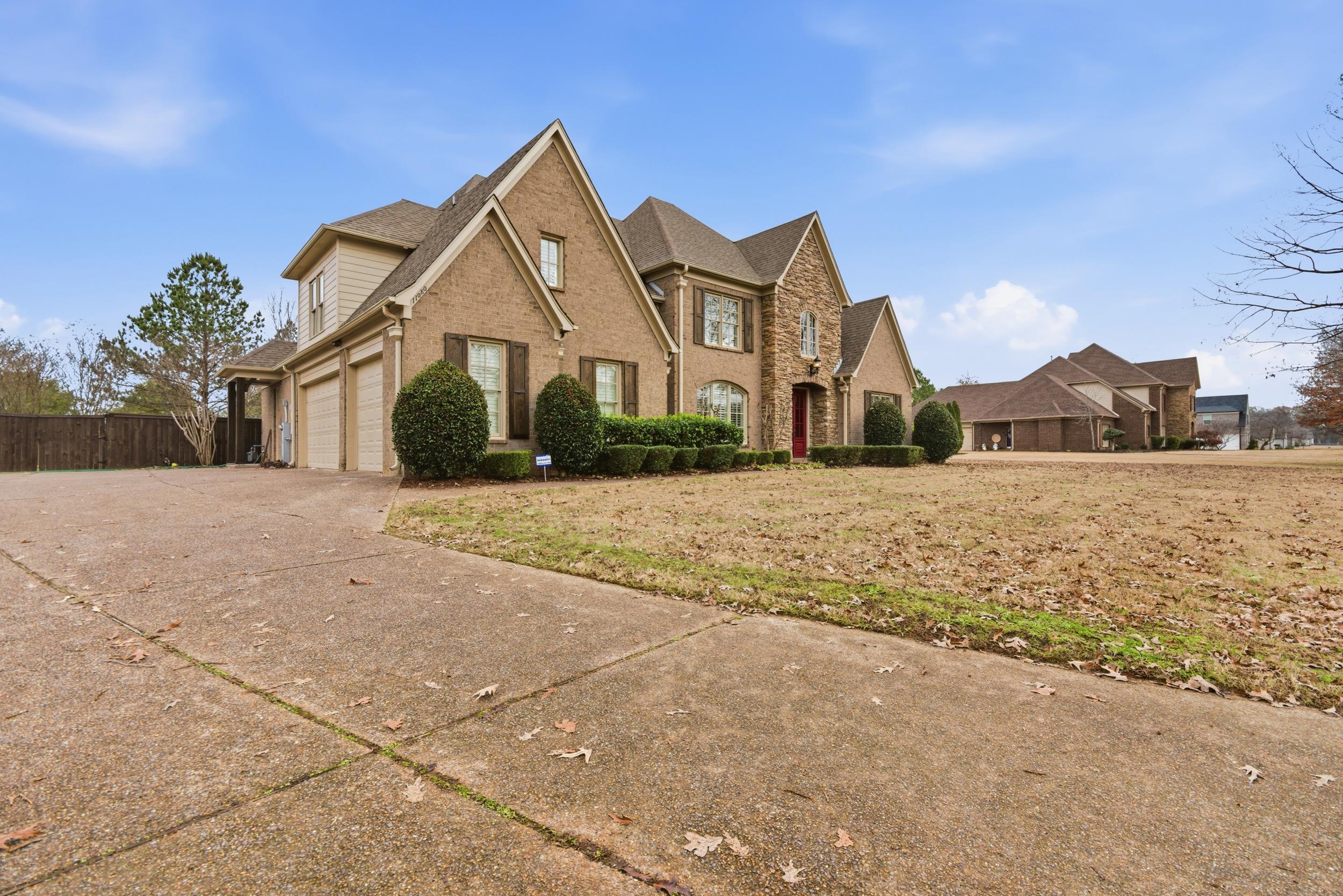 11080 Shelby Post Road Collierville, TN 38017 - Photo 3 of 39 Traditional-style house featuring brick siding, driveway, roof with shingles, and an attached garage