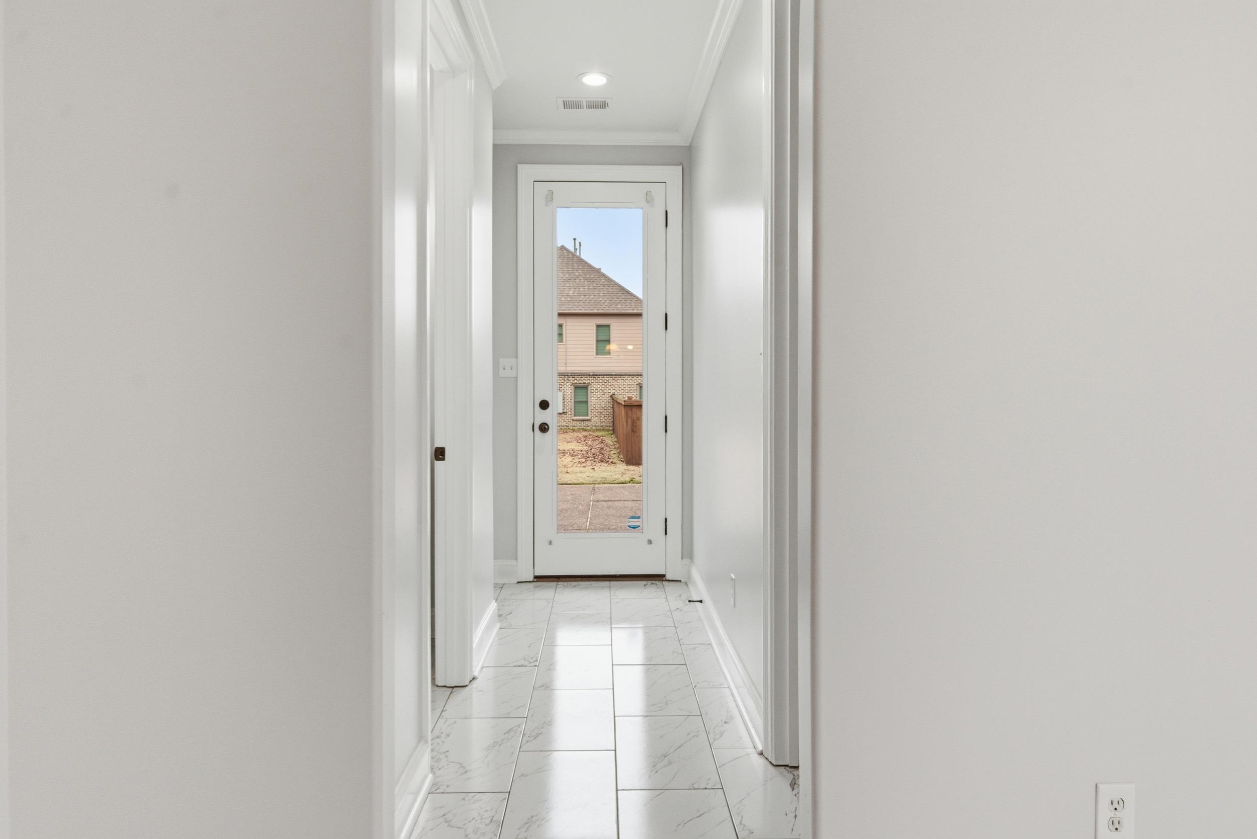 11080 Shelby Post Road Collierville, TN 38017 - Photo 32 of 39 Hallway featuring light marble finish floors and crown molding